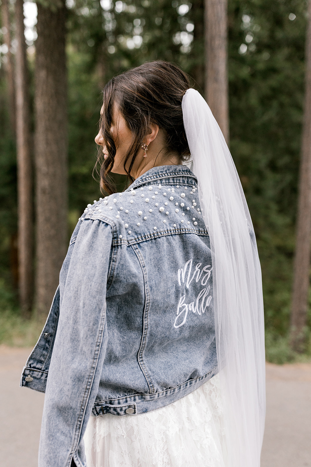 Detail photo of the bride’s pearl embroidered jean jacket