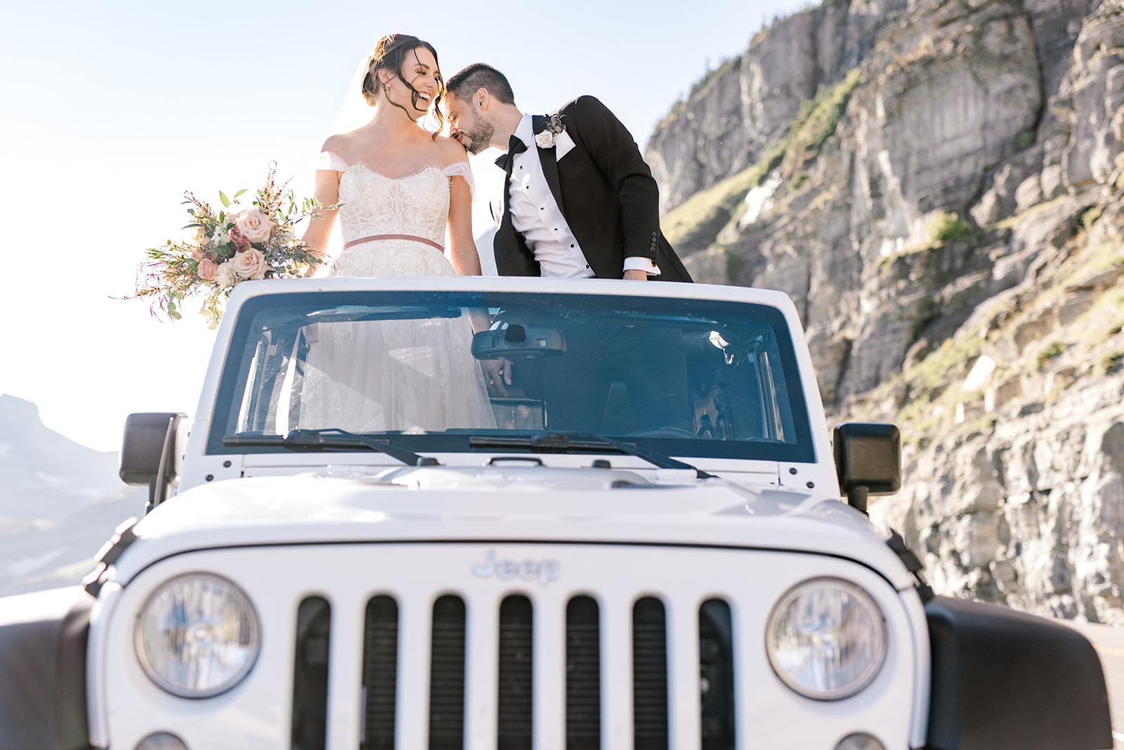 Bride and Groom in their Jeep rental in Glacier National Park