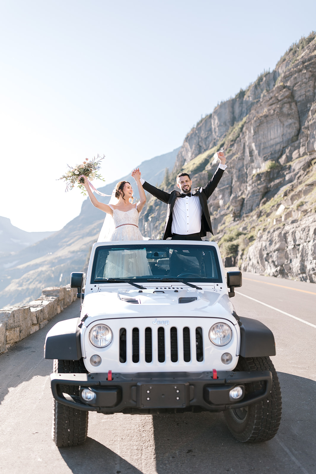 Bride and Groom in their Jeep rental in Glacier National Park