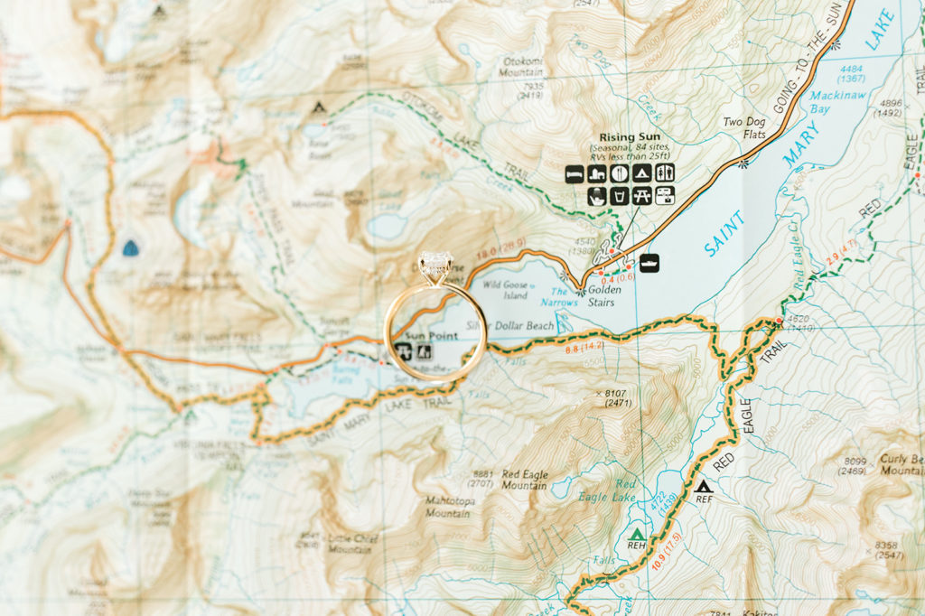 Bride’s engagement ring centered on top of the ceremony site on the Glacier National Park Map
