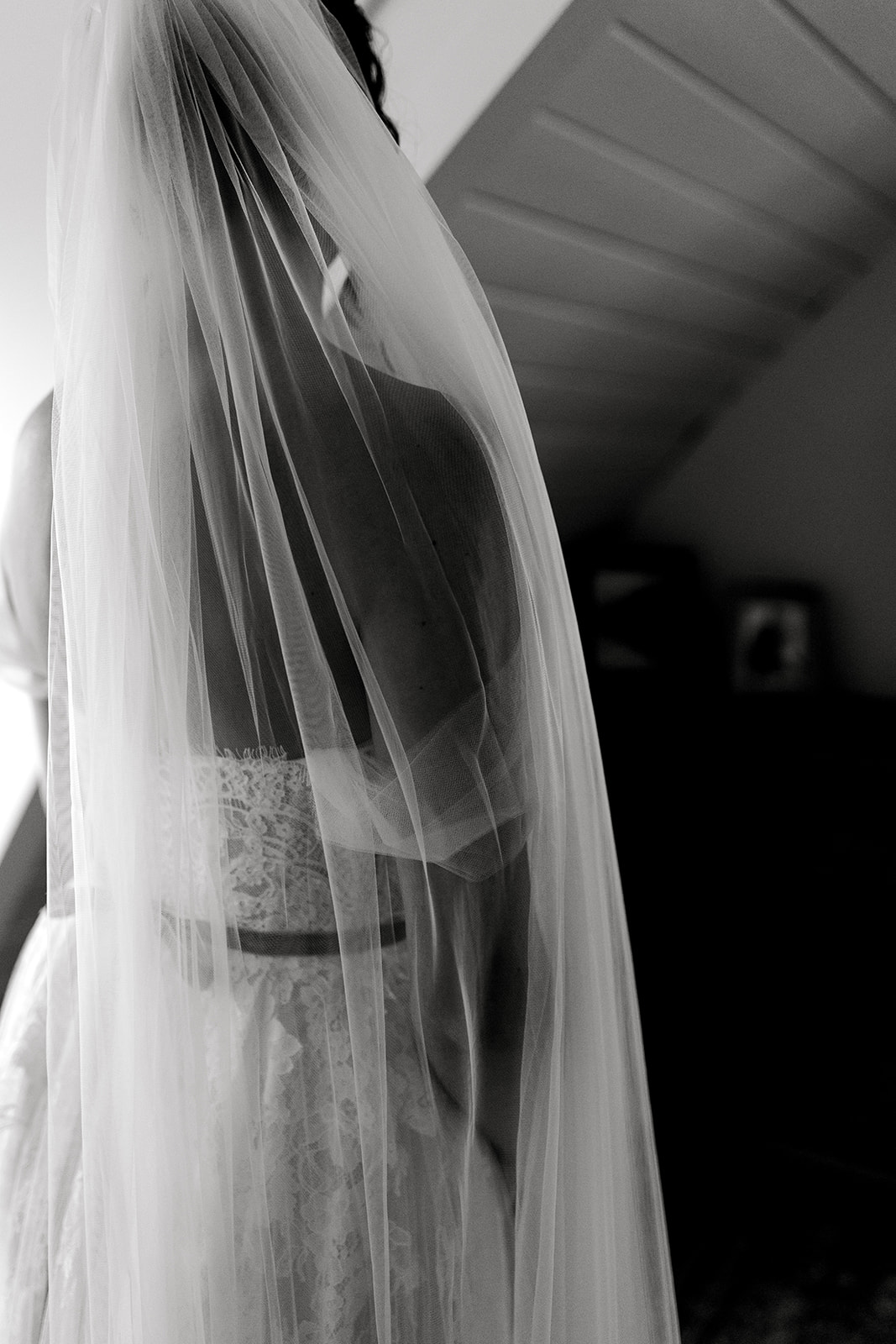 Details of the bride’s veil over her shoulders as she gets ready to leave for ceremony