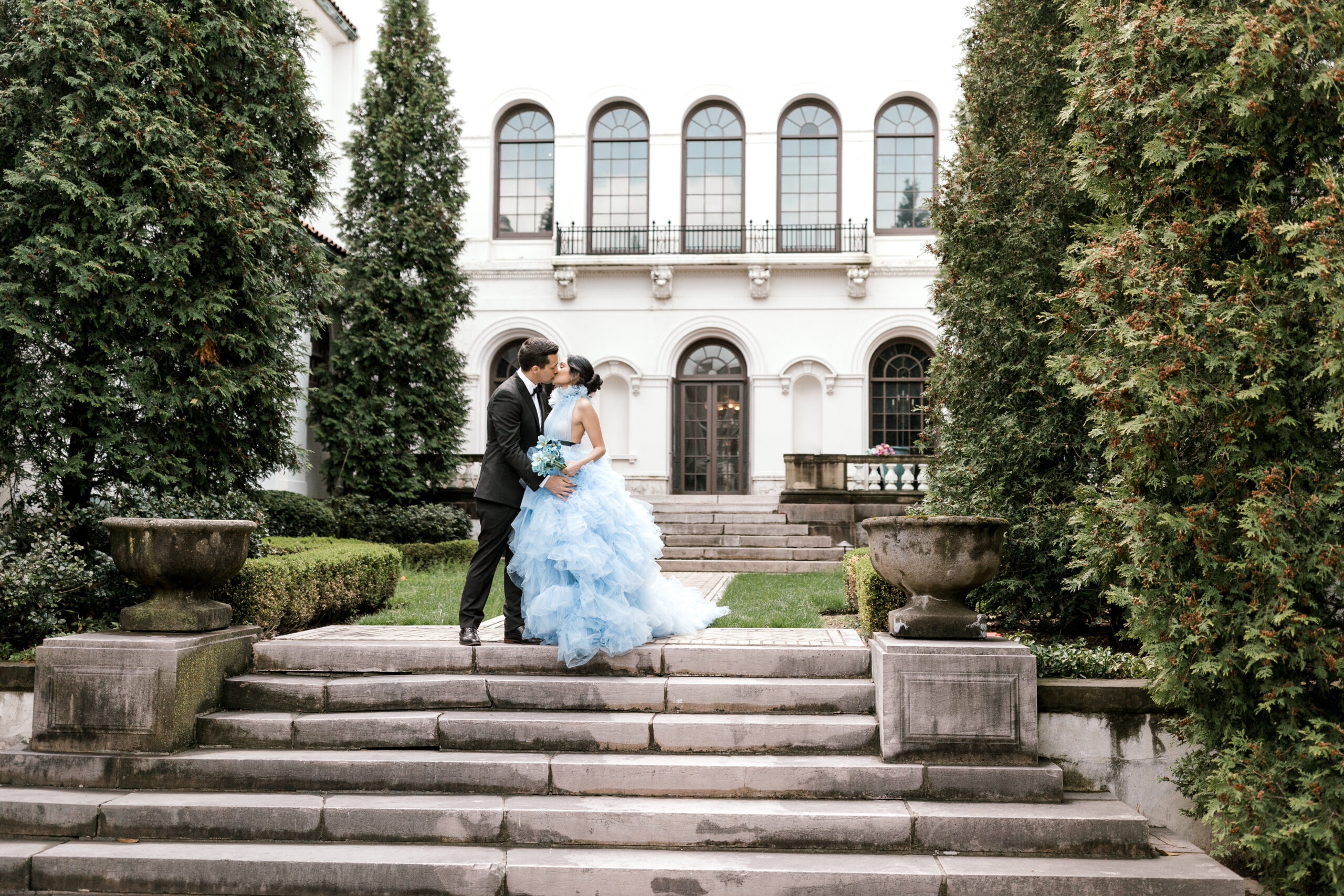 Bride and groom stand on the steps of the Hay Mansion Gardens in Cleveland OH